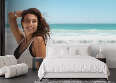 Happy fashion woman smiling at beach Wall mural