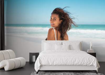 Happy girl running on beach Wall mural