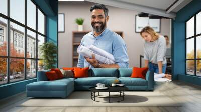 Happy latin architect holding blueprints Wall mural