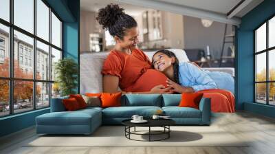 Happy lovely daughter hugging pregnant mother Wall mural