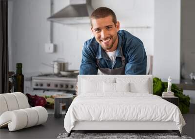 Happy man ready to cook in kitchen Wall mural