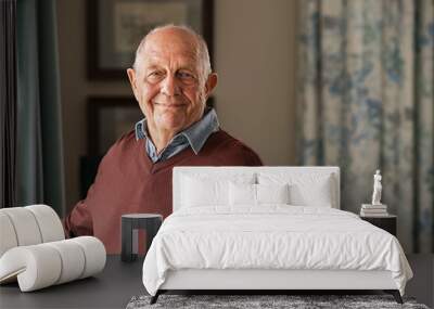 Happy senior man looking at camera at home Wall mural