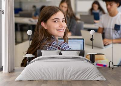 Happy smiling college girl studying on laptop Wall mural