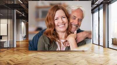 Happy smiling mature couple at home Wall mural