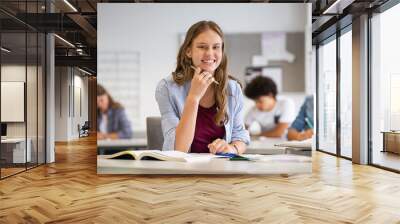 Happy smiling student girl studying in classroom Wall mural