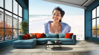 Happy smiling woman running on beach in a beautiful summer day Wall mural