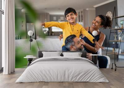 Happy son playing with parents at home Wall mural