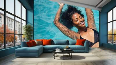 Happy woman relaxing in swimming pool Wall mural