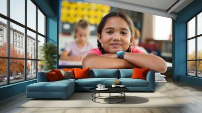 Hispanic girl with chin on books Wall mural