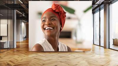 Joyful mature african woman laughing and looking away Wall mural