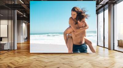 Loving couple enjoy summer at beach Wall mural