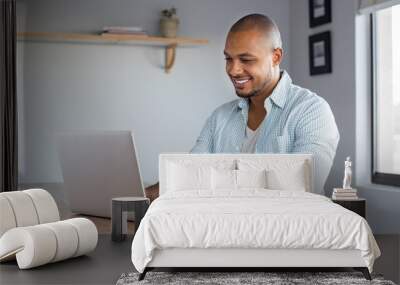 Man working on laptop at home Wall mural