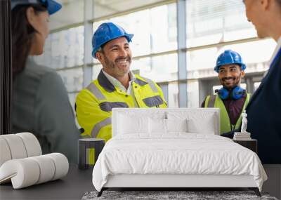 Mature architect and contractor shaking hands at construction site Wall mural