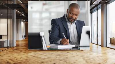 Mature businessman writing on documents Wall mural