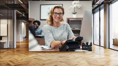 Mature casual woman working on computer Wall mural