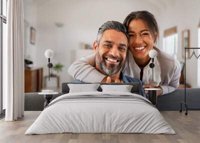 Mature indian couple hugging and looking at camera Wall mural