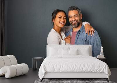 Mature multiethnic couple embracing and smiling together Wall mural