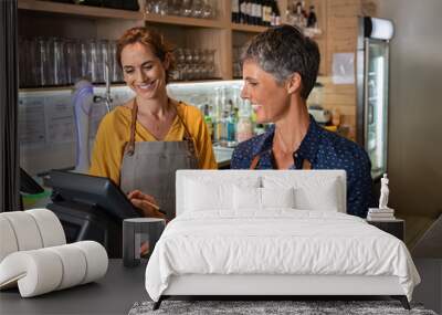 Mature women waitress working at coffee shop Wall mural