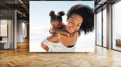 Mother and daughter having fun at beach Wall mural