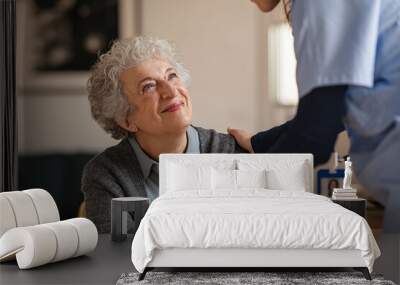 Nurse take care of senior woman Wall mural