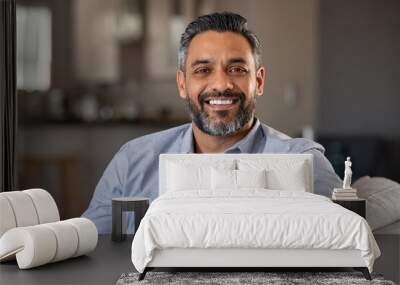 Portrait of happy indian man smiling at home Wall mural