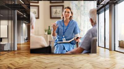 Psychologist having session with seniors at care facility centre Wall mural