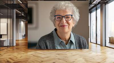 Senior smiling woman with spectacles looking at camera Wall mural