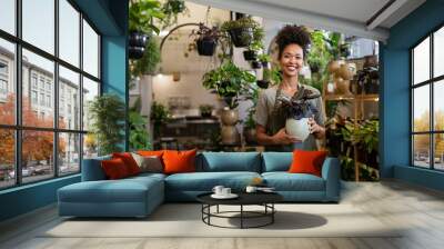 Small business owner smiling in her plant shop Wall mural