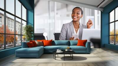 Smiling businesswoman looking up while working Wall mural