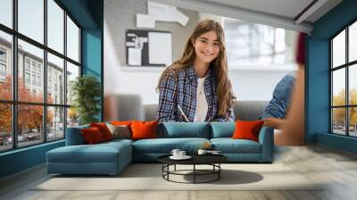 Smiling college girl studying in classroom Wall mural