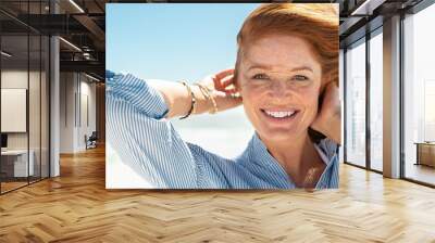 smiling mature woman at beach Wall mural