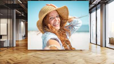 Smiling mature woman with straw hat Wall mural