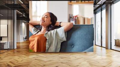 Smiling multiethnic woman relaxing at home with copy space Wall mural