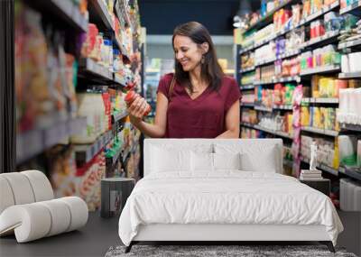 Smiling woman at supermarket Wall mural