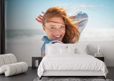 Smiling woman enjoying summer at beach Wall mural