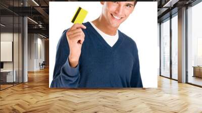 Smiling young man with credit card Wall mural