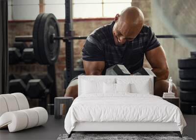 Strong man lifting weight at gym Wall mural