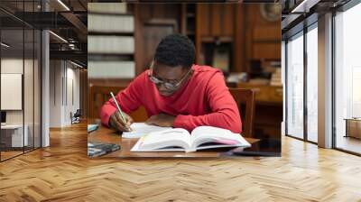 Student in library studying for exam Wall mural