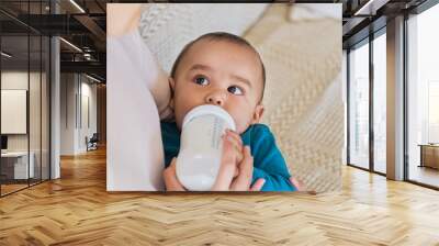 Toddler drinking from milk bottle Wall mural