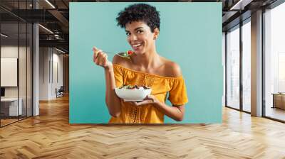 Woman eating salad Wall mural