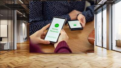 Woman receiving digital money using phone Wall mural