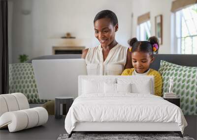 Woman working from home while her daughter using digital tablet Wall mural