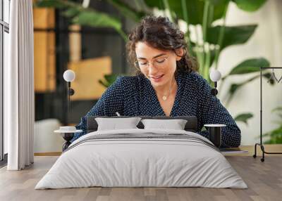 Woman writing down notes on agenda Wall mural