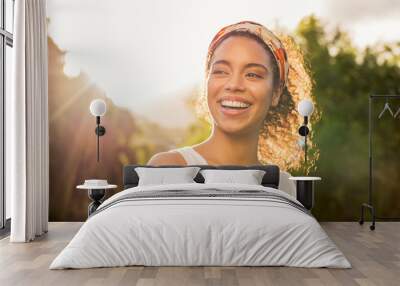 young african woman smiling at sunset Wall mural