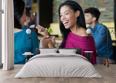 Young beautiful woman eating salad Wall mural