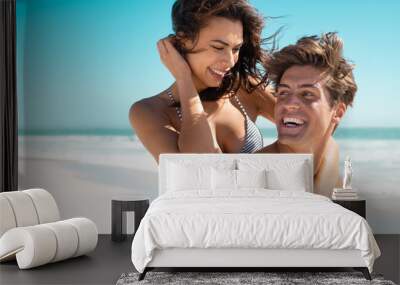 Young couple having fun at beach Wall mural