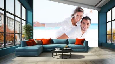 Young couple together at beach Wall mural