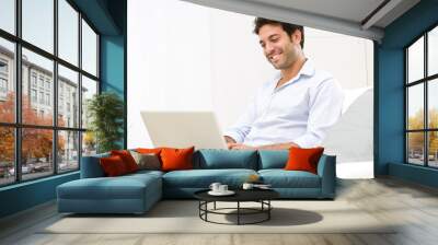 Young man at laptop Wall mural