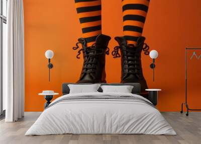 A pair of witch's boots with curled toes and striped stockings isolated on color background Wall mural