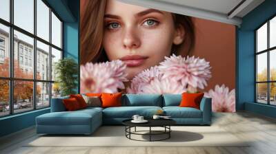 Beautiful young women with bouquet of pink chrysanthemum flowers on brown background. International Women's Day Wall mural